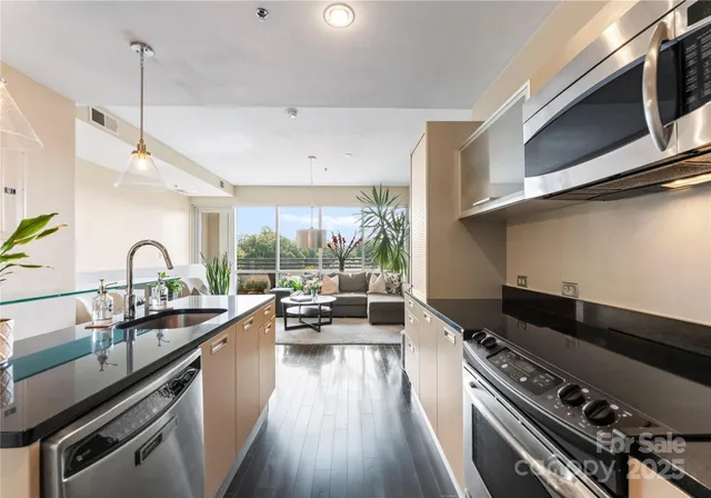 a kitchen with a stove a sink and a wooden floors