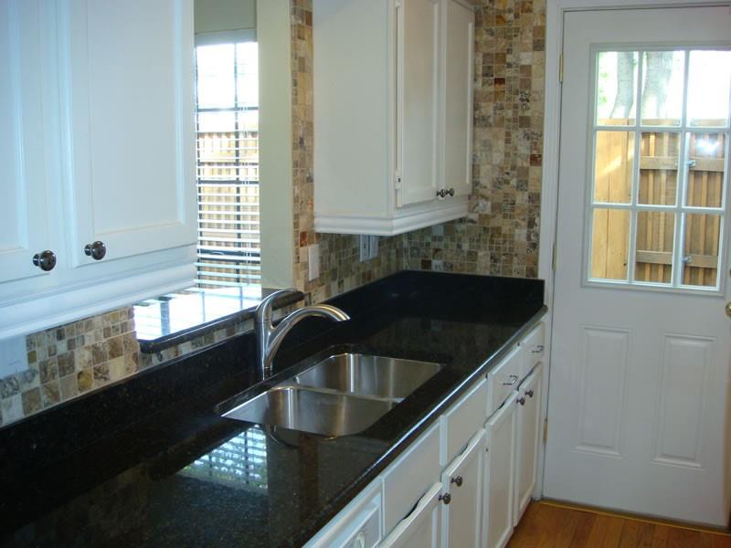 4000 Rawlins Street, Unit 105 Dallas, TX 75219 - Photo 12 of 26 a kitchen that has a sink and a window