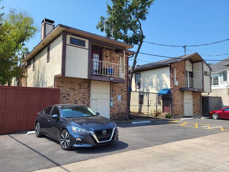 4000 Rawlins Street, Unit 105 Dallas, TX 75219 - Photo 2 of 26 a car parked in front of a house