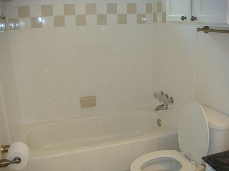 4000 Rawlins Street, Unit 105 Dallas, TX 75219 - Photo 21 of 26 a bathroom with a toilet and a bathtub