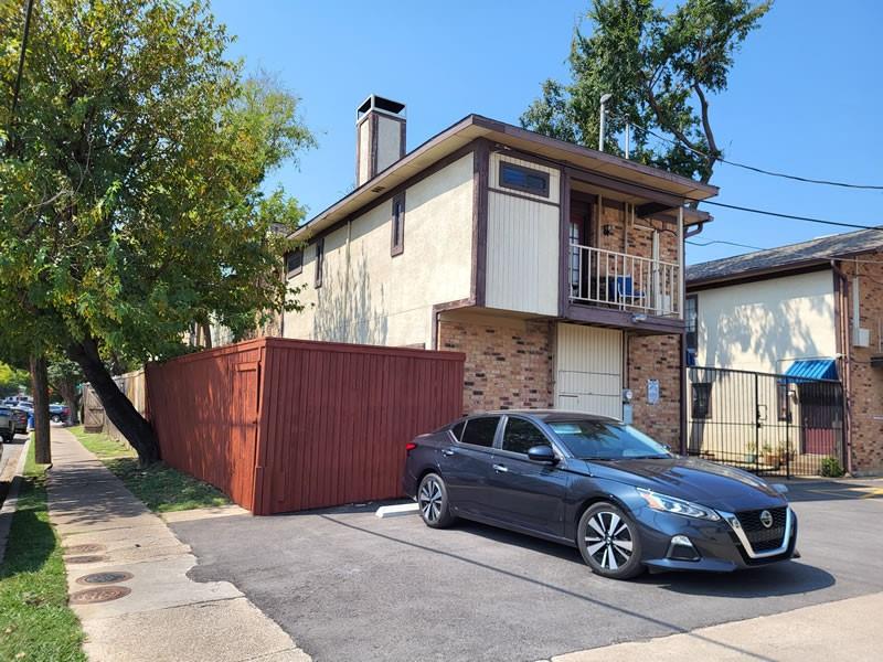4000 Rawlins Street, Unit 105 Dallas, TX 75219 - Photo 3 of 26 a car parked in front of a house