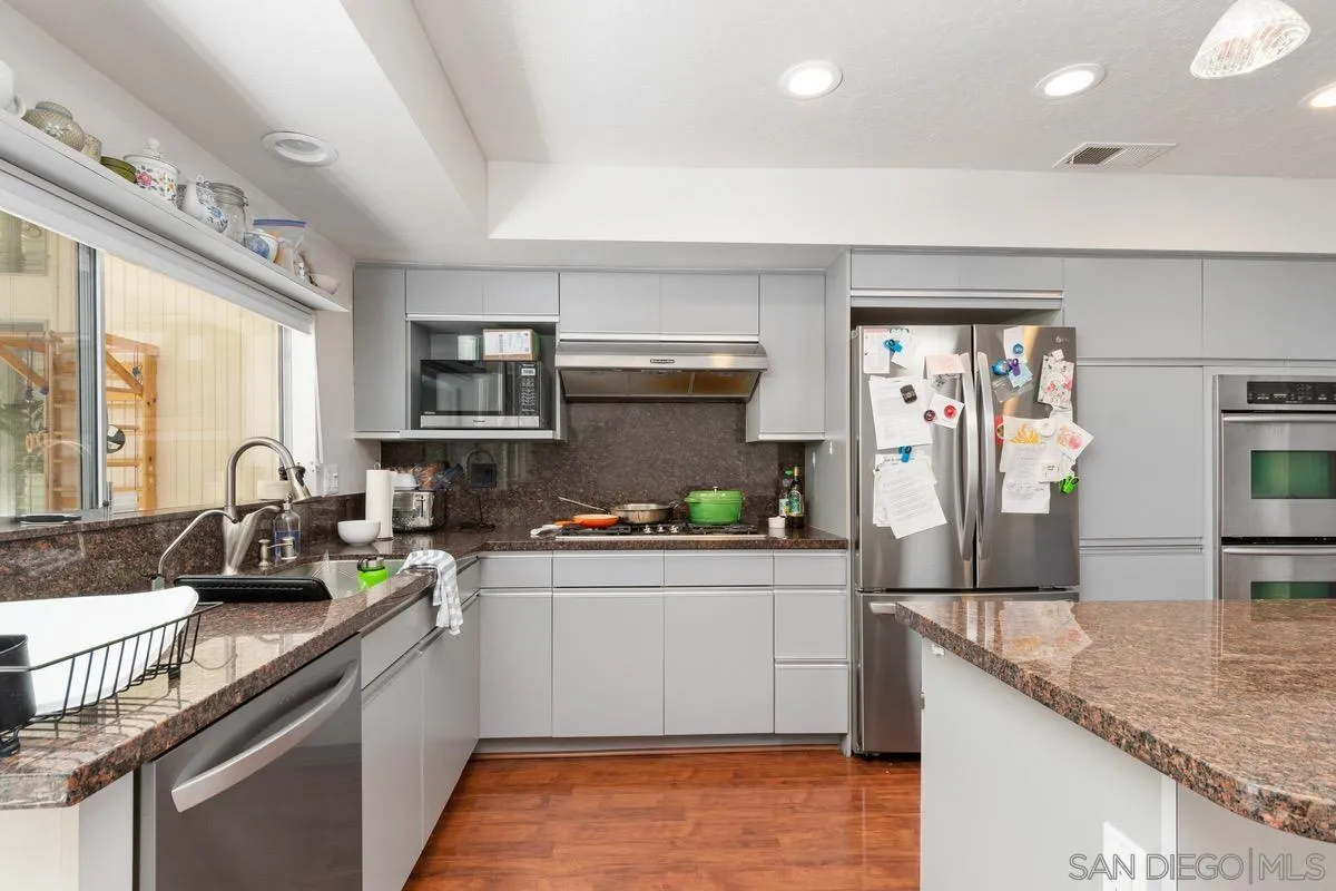 6729 Avenida Andorra La Jolla, CA 92037 - Photo 10 of 27 a kitchen with stainless steel appliances granite countertop a sink stove and refrigerator
