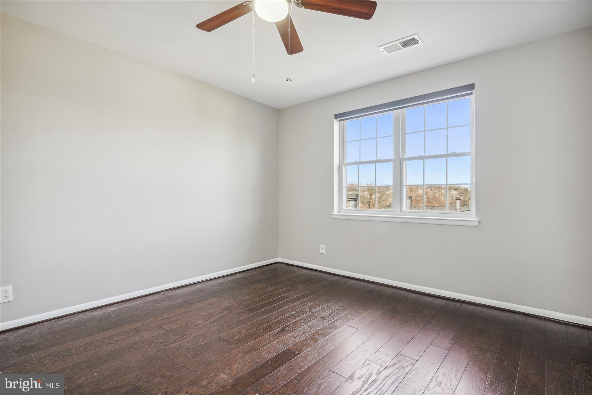 4613 28th Road South, Unit C Arlington, VA 22206 - Photo 15 of 37 a view of an empty room with wooden floor and a window