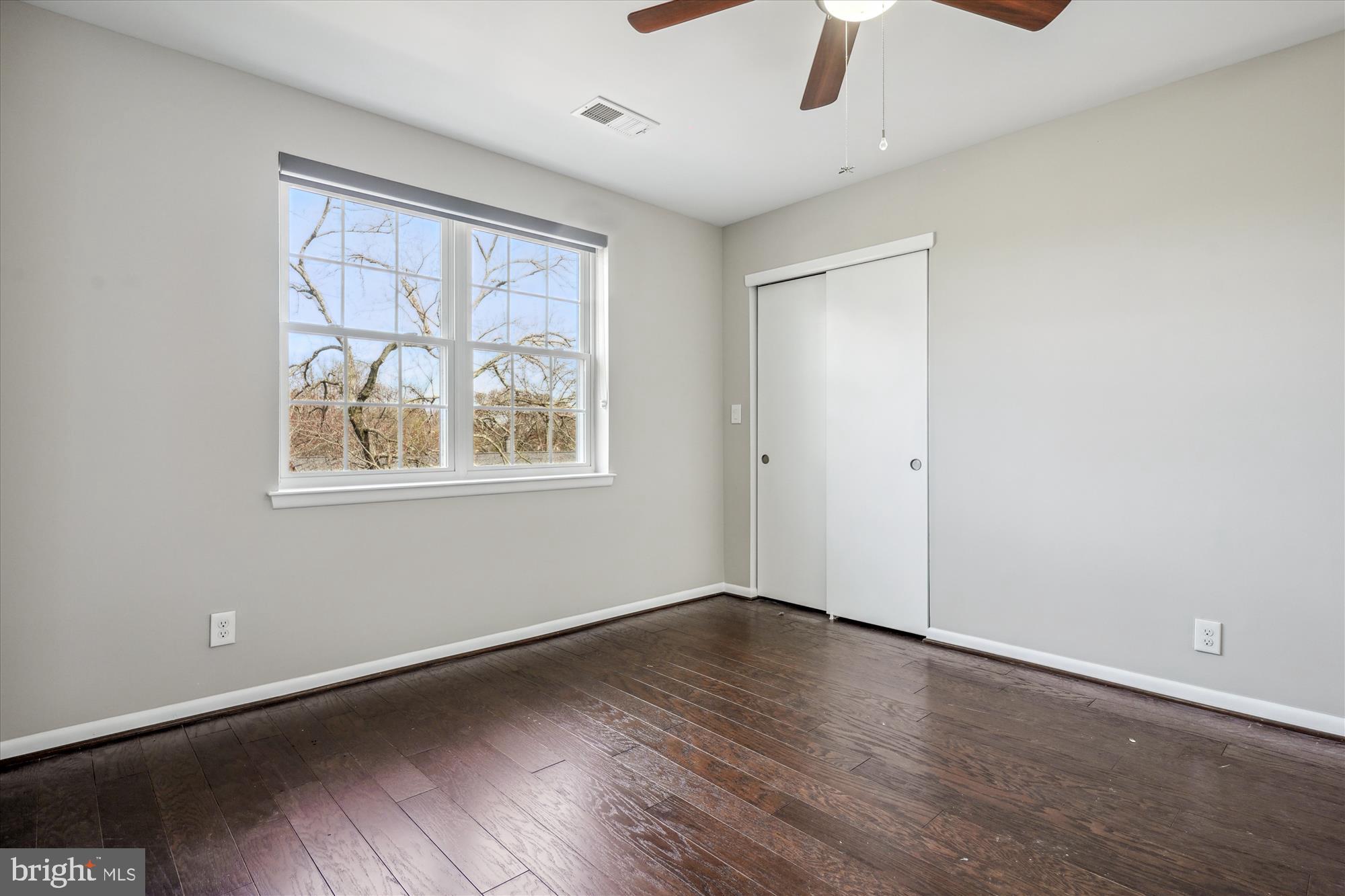 4613 28th Road South, Unit C Arlington, VA 22206 - Photo 16 of 37 a view of an empty room with window and wooden floor