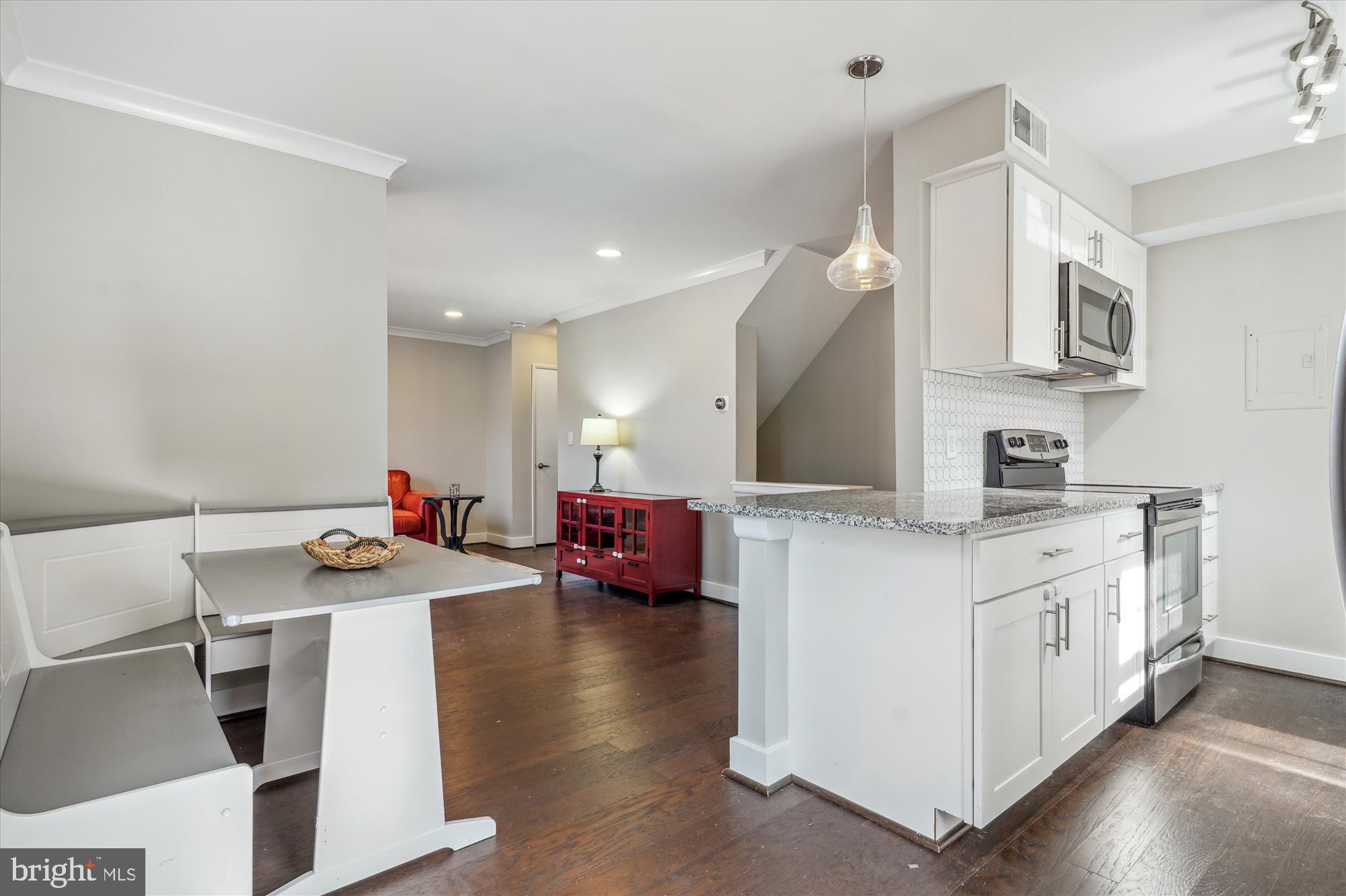 4613 28th Road South, Unit C Arlington, VA 22206 - Photo 8 of 37 a open kitchen with stainless steel appliances a stove a sink dishwasher and a refrigerator with wooden floor