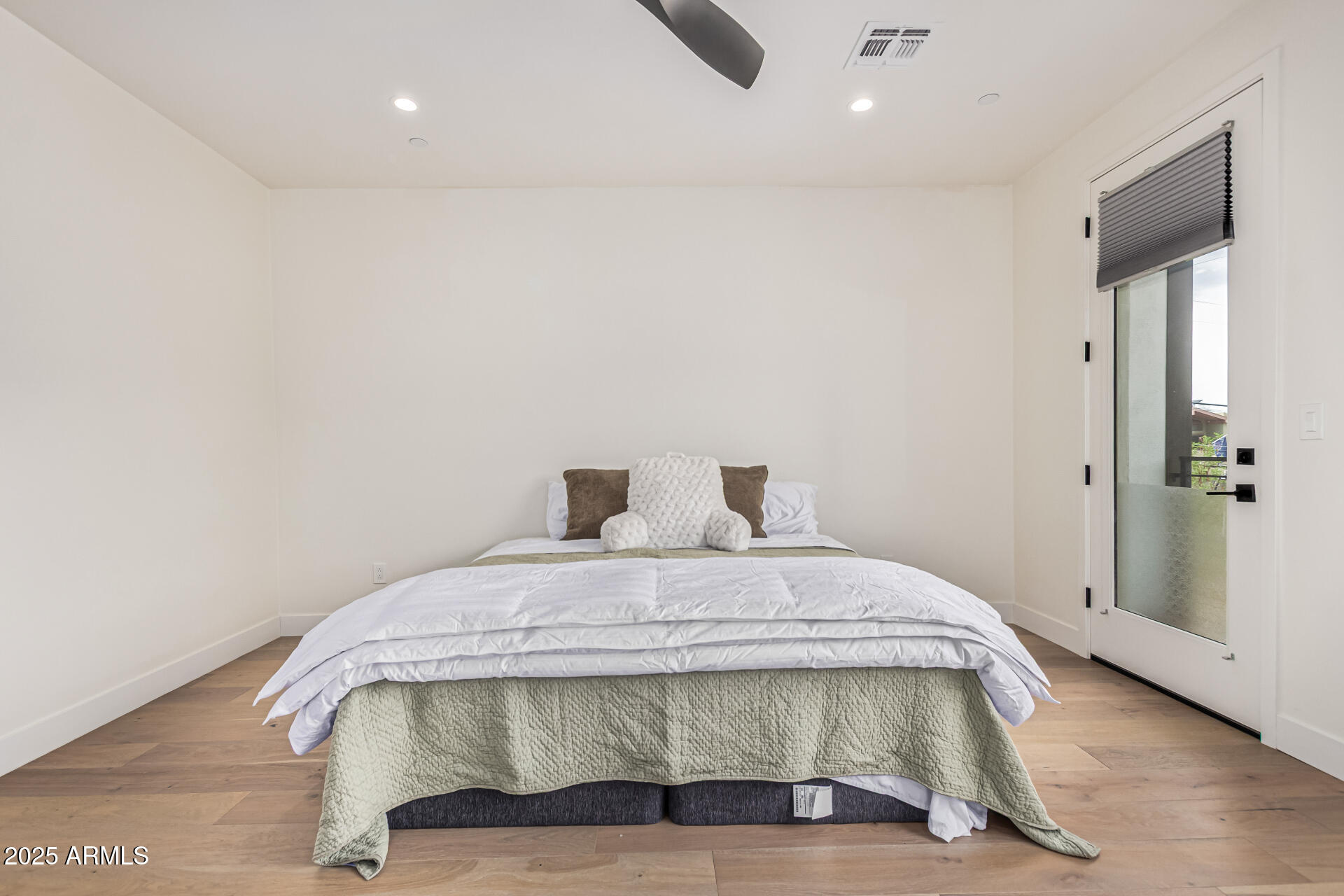 5151 North 13th Place, Unit 12 Phoenix, AZ 85014 - Photo 14 of 31 a bedroom with a bed and wooden floor