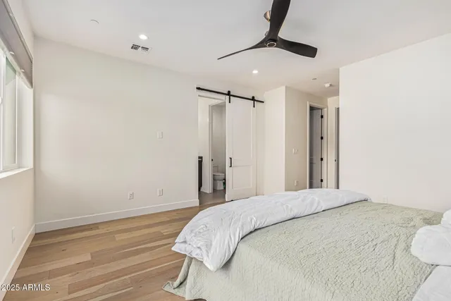 a bedroom with a bed and a chandelier