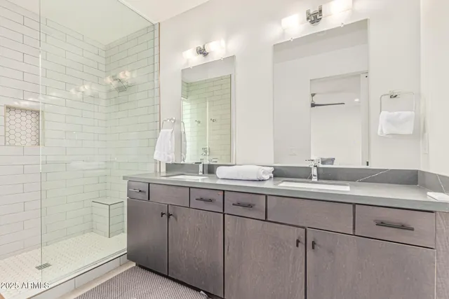 a bathroom with a granite countertop sink mirror and double