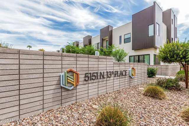 a view of a house with a big yard and large trees