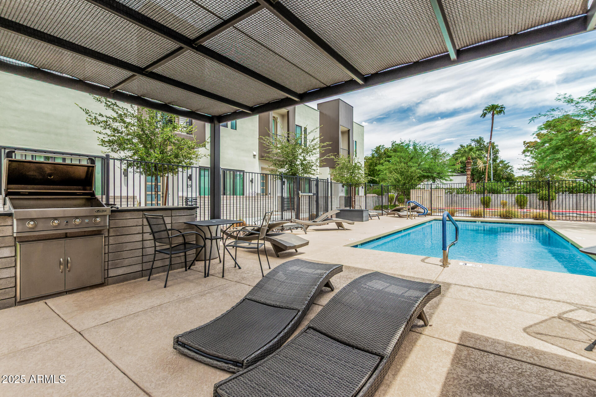 5151 North 13th Place, Unit 12 Phoenix, AZ 85014 - Photo 27 of 31 a swimming pool with chairs in front of it
