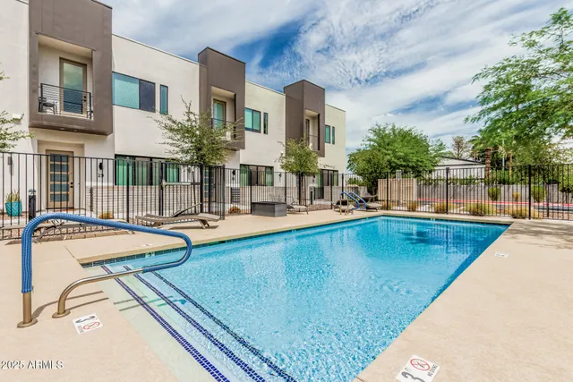 a swimming pool with outdoor seating and yard