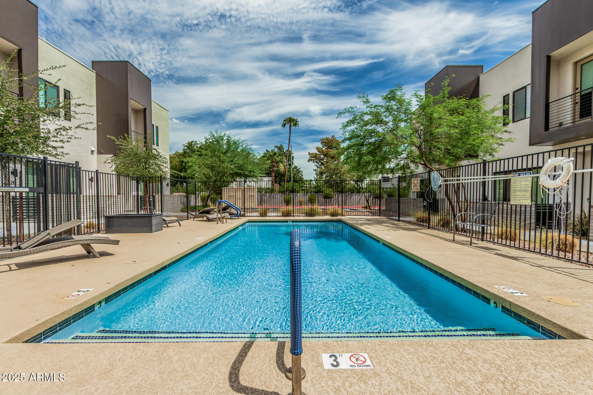 5151 North 13th Place, Unit 12 Phoenix, AZ 85014 - Photo 29 of 31 a swimming pool with outdoor seating and yard