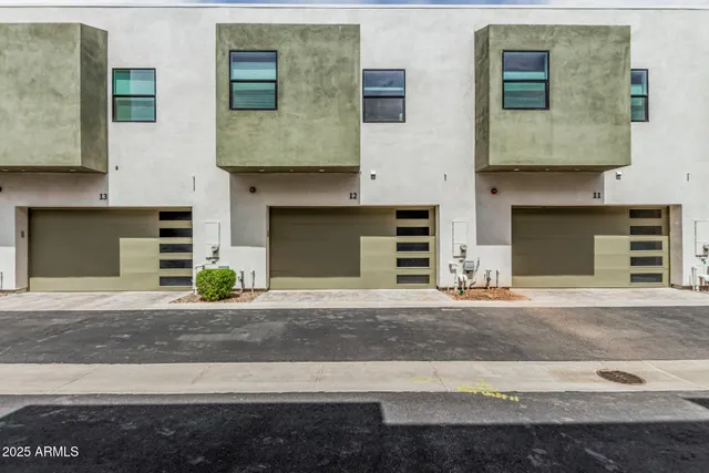 a front view of a house with a yard and a garage