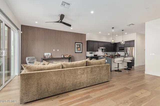 a living room with furniture and kitchen view