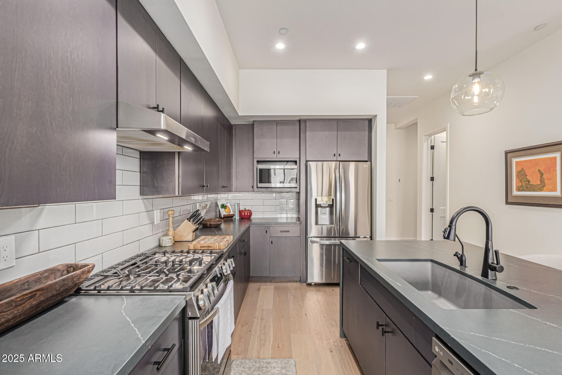 5151 North 13th Place, Unit 12 Phoenix, AZ 85014 - Photo 10 of 31 a kitchen with stainless steel appliances granite countertop a sink stove and refrigerator