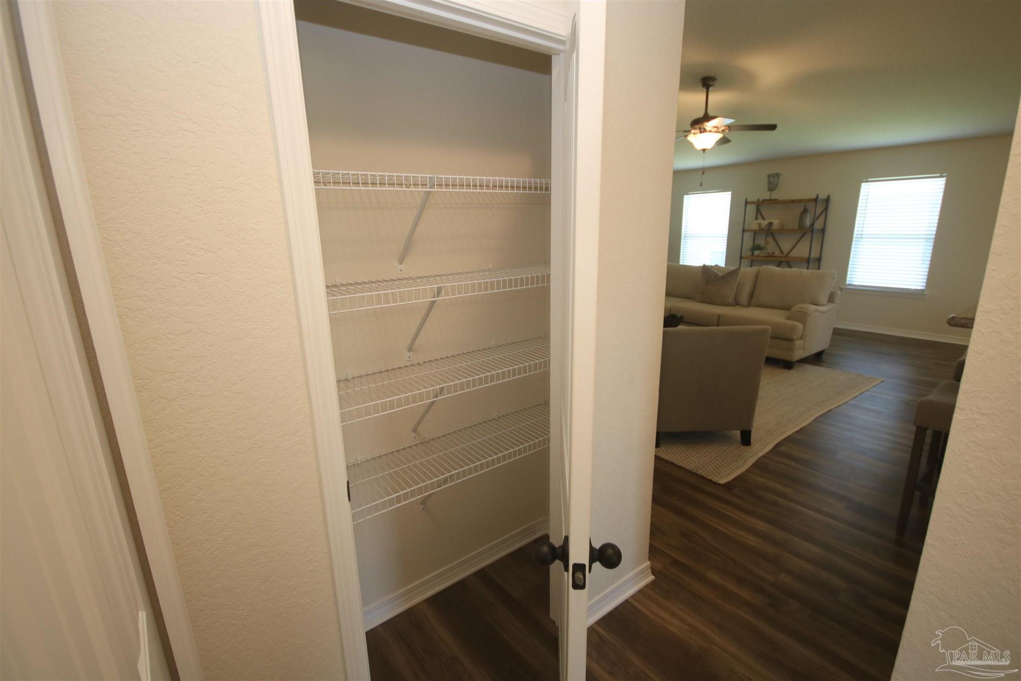 5747 Peach Drive Pace, FL 32571 - Photo 23 of 65 left. Large linen closet outside master bedroom.