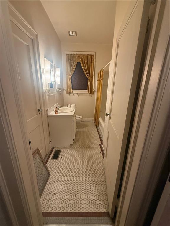2808 Summerville Road Phenix City, AL 36867 - Photo 11 of 15 Bathroom featuring vanity, shower / bath combo with shower curtain, and light tile patterned floors