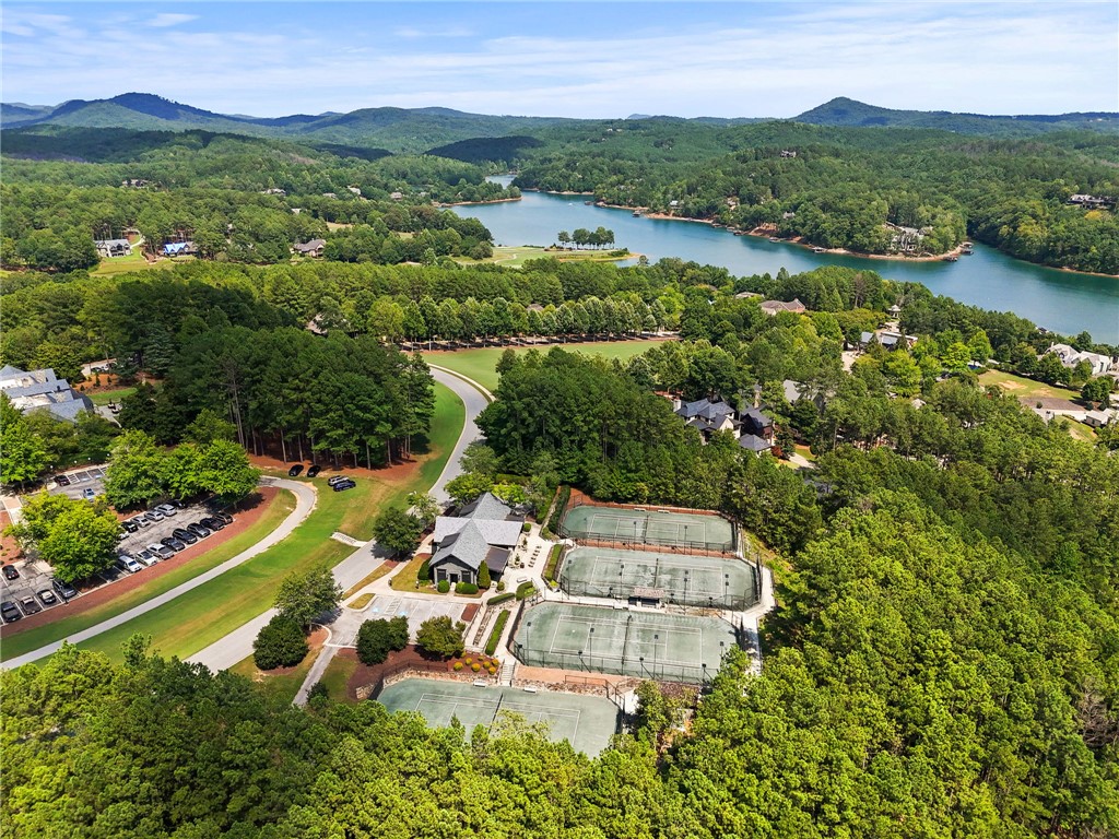 314 Palmer Way Sunset, SC 29685 - Photo 40 of 48 An aerial perspective reveals a vibrant community nestled among lush trees and a serene lake, featuring well-maintained tennis courts.