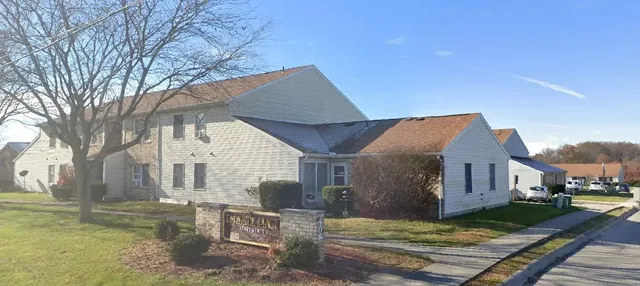 a view of a house with backyard and sitting area