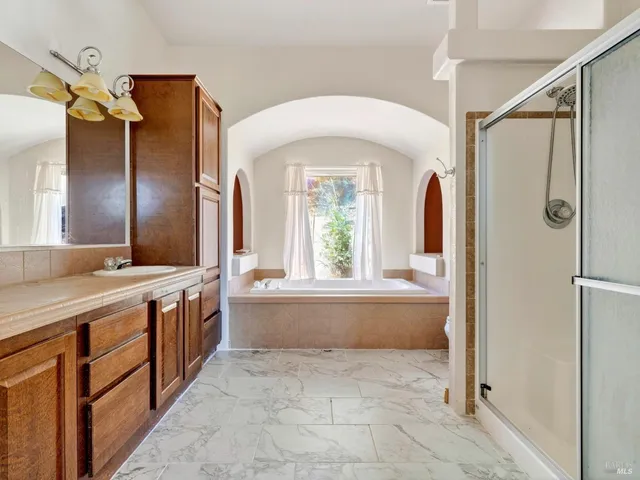 a bathroom with a bathtub and a window