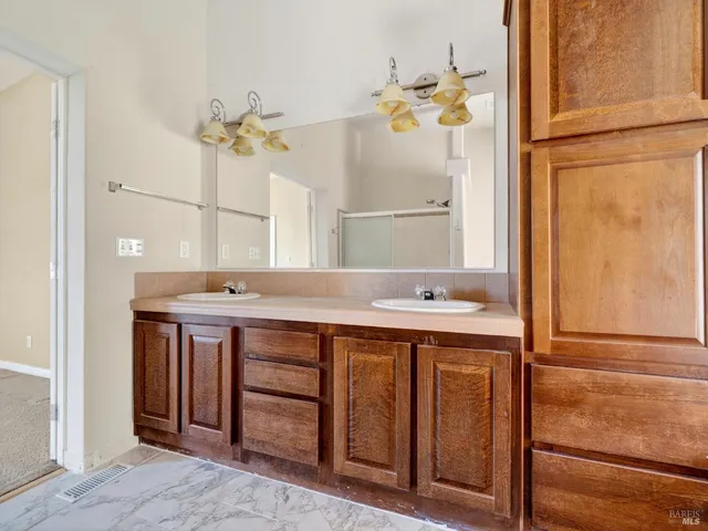 a view of a hallway with wooden floor and windows
