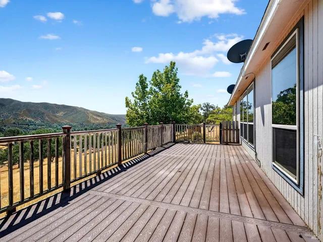 a view of a house with backyard and wooden floor