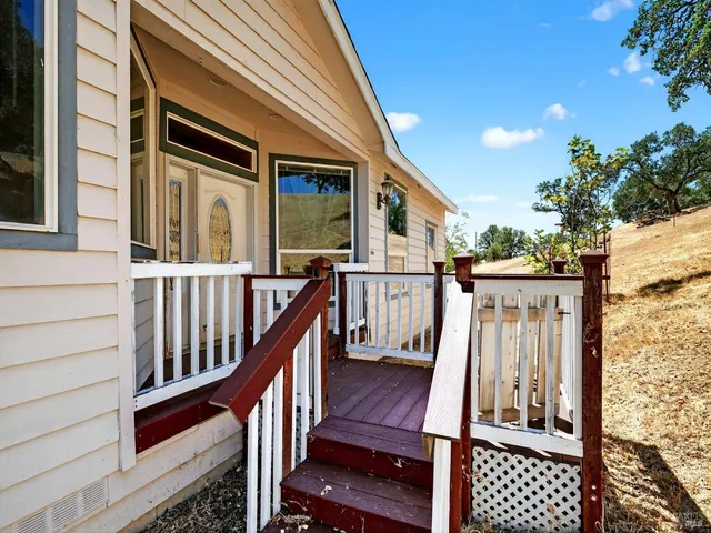 a view of a house with a backyard and mountain
