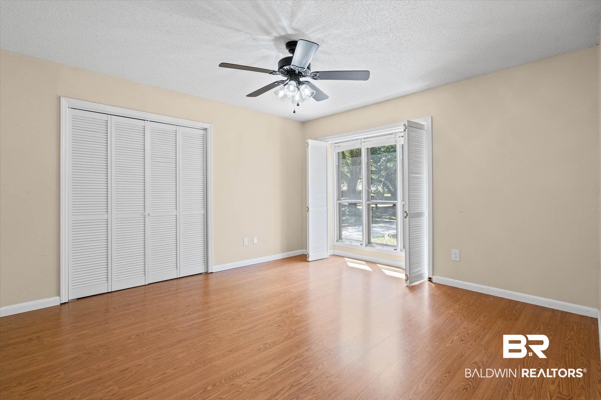3724 Claridge Road South Mobile, AL 36608 - Photo 23 of 42 Unfurnished bedroom featuring a textured ceiling, wood finished floors, a ceiling fan, and a closet