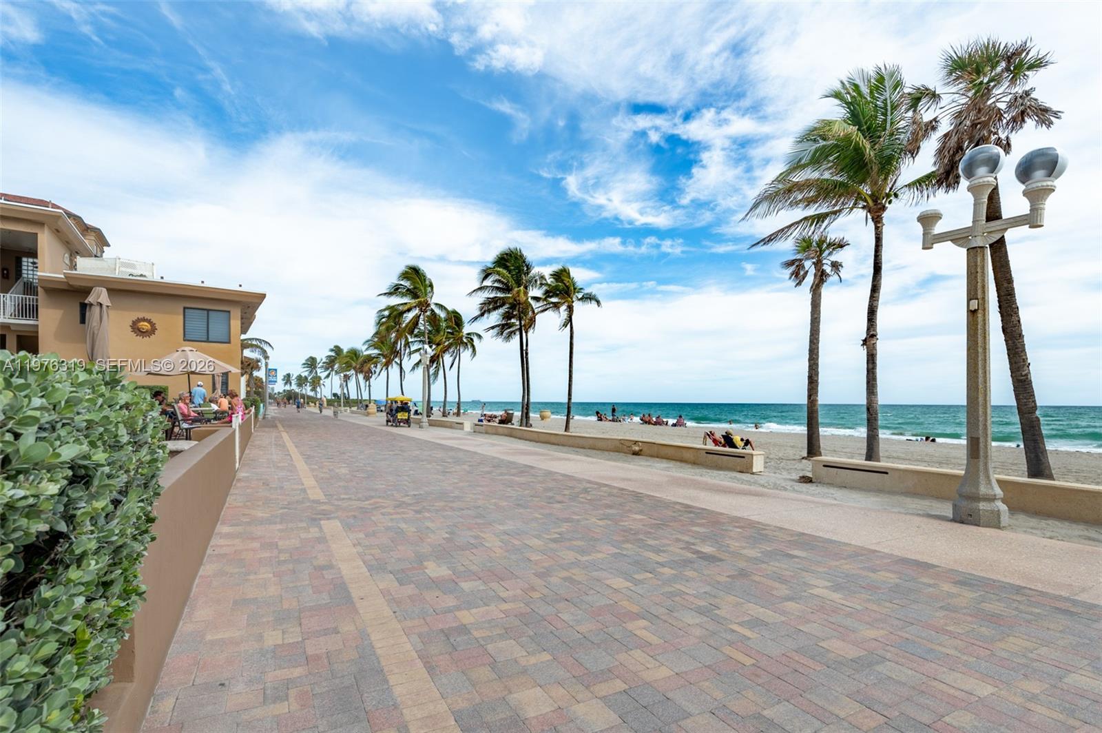 3300 North Surf Road, Unit 26A Hollywood, FL 33019 - Photo 12 of 19 a row of palm trees and swimming pool in the backyard of a house