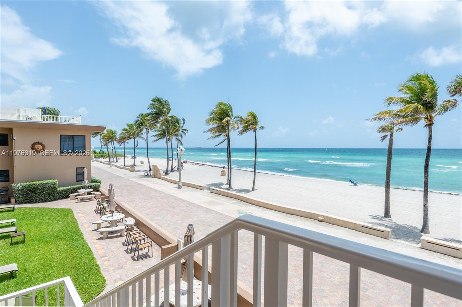 3300 North Surf Road, Unit 26A Hollywood, FL 33019 - Photo 14 of 19 a view of a backyard with couches under an umbrella