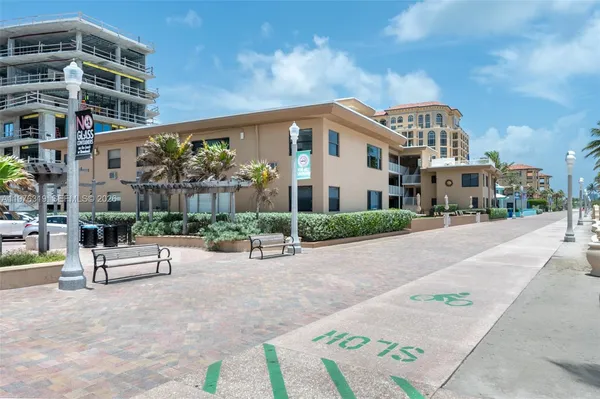 a view of a building with a bench in a patio