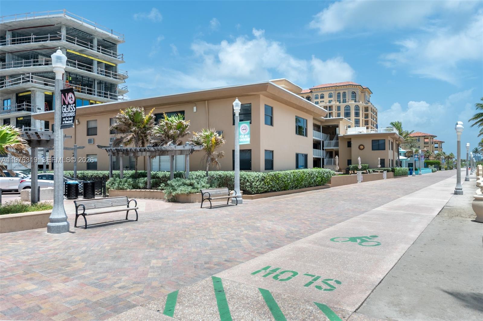 3300 North Surf Road, Unit 26A Hollywood, FL 33019 - Photo 16 of 19 a view of a building with a bench in a patio