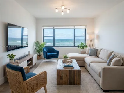 a living room with furniture potted plant and a large window
