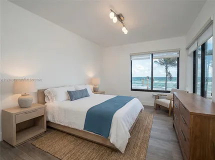 a bedroom with a large bed and a balcony