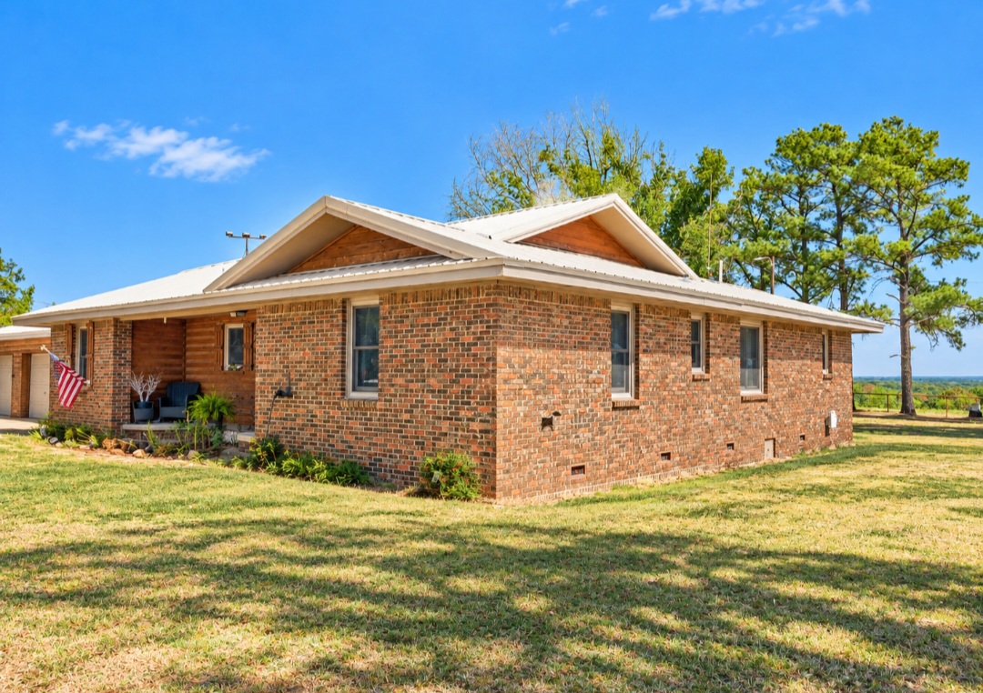 12526 3520th Road Seminole, OK 74868 - Photo 4 of 42 Charming brick ranch home situated on expansive grounds with mature landscaping and tall pine trees