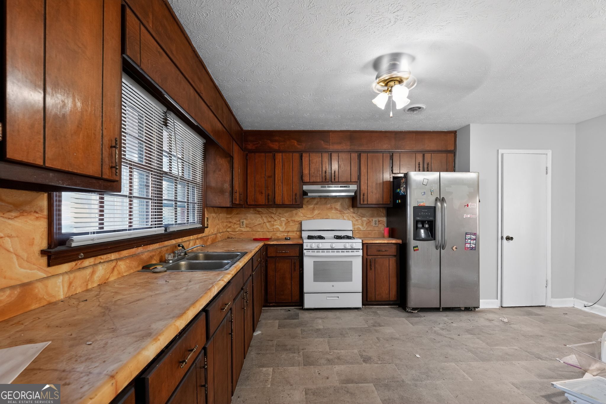 2653 Lester Street Atlanta, GA 30344 - Photo 11 of 34 a kitchen with stainless steel appliances granite countertop a refrigerator a stove top oven a sink and dishwasher