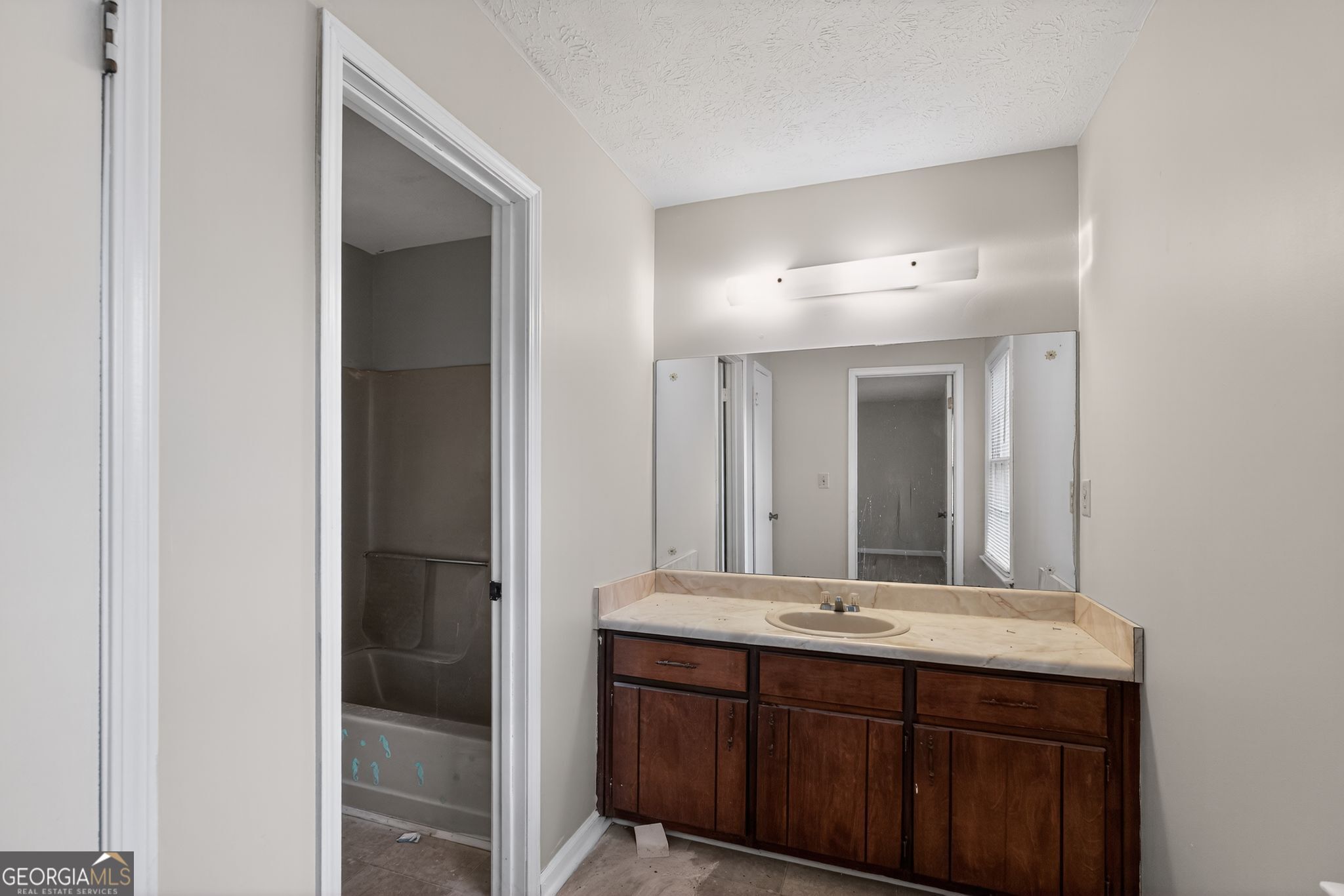 2653 Lester Street Atlanta, GA 30344 - Photo 22 of 34 a bathroom with a double vanity sink and a mirror