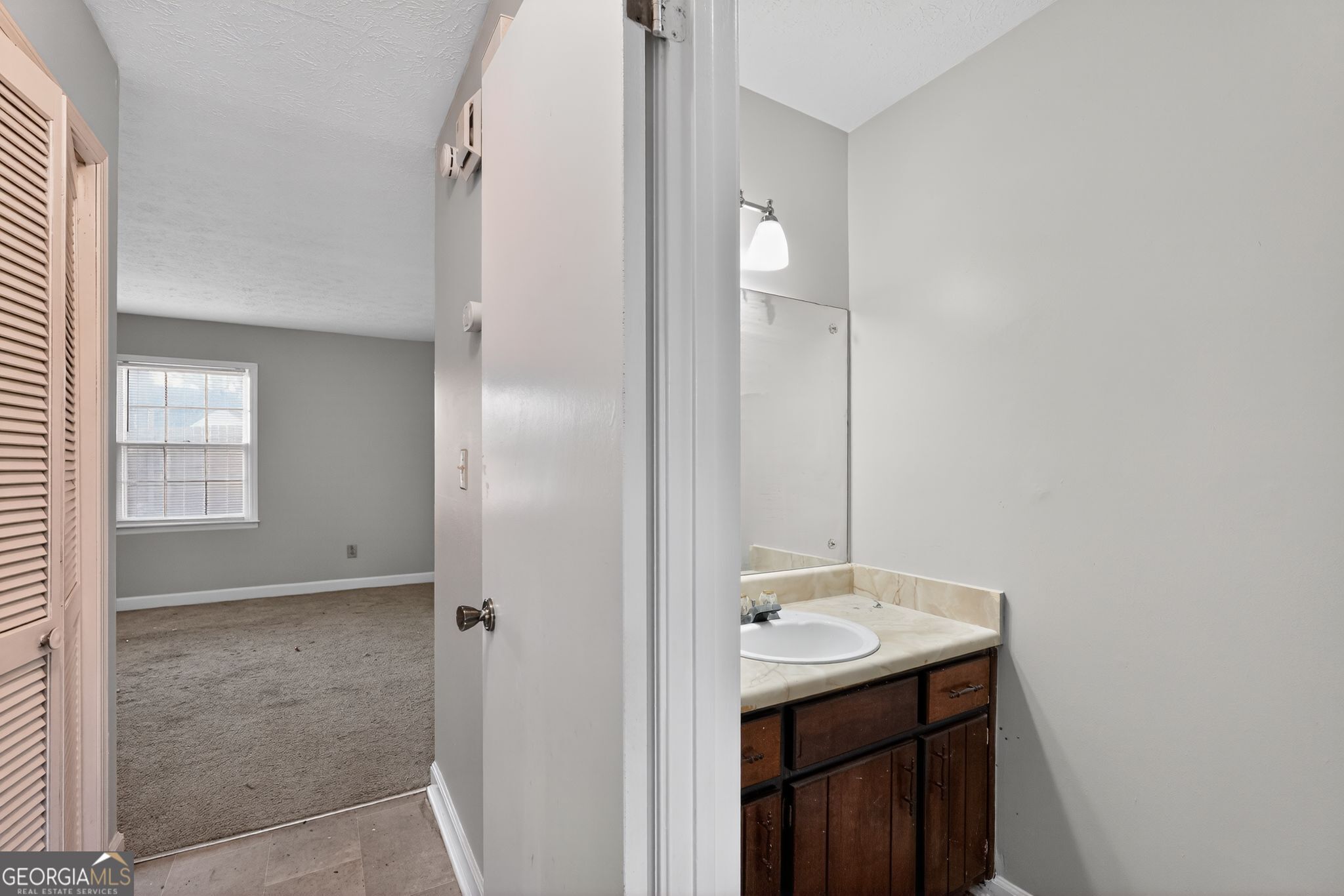 2653 Lester Street Atlanta, GA 30344 - Photo 23 of 34 a bathroom with a sink a mirror and a shower