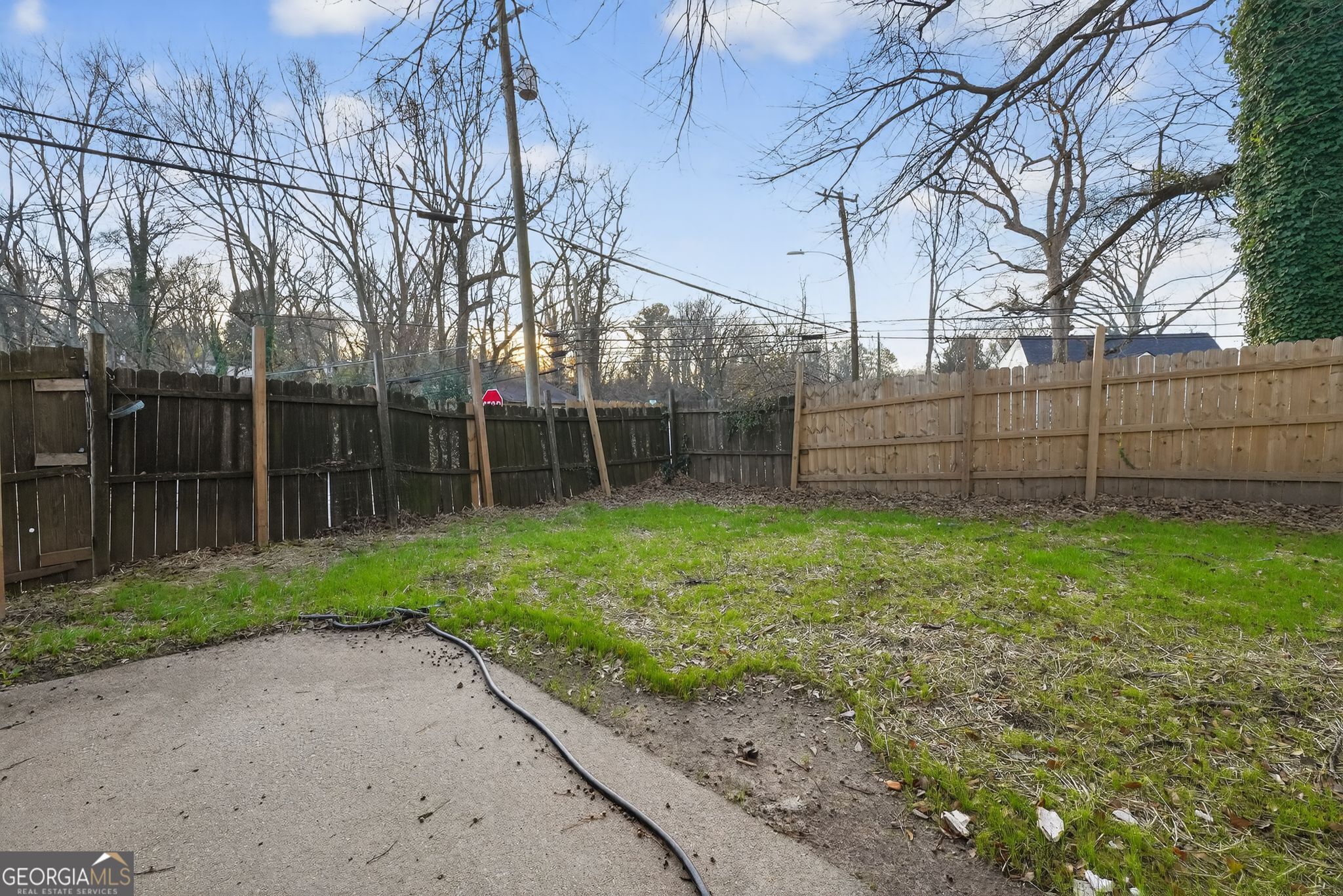 2653 Lester Street Atlanta, GA 30344 - Photo 30 of 34 a view of a backyard with a large tree and wooden fence