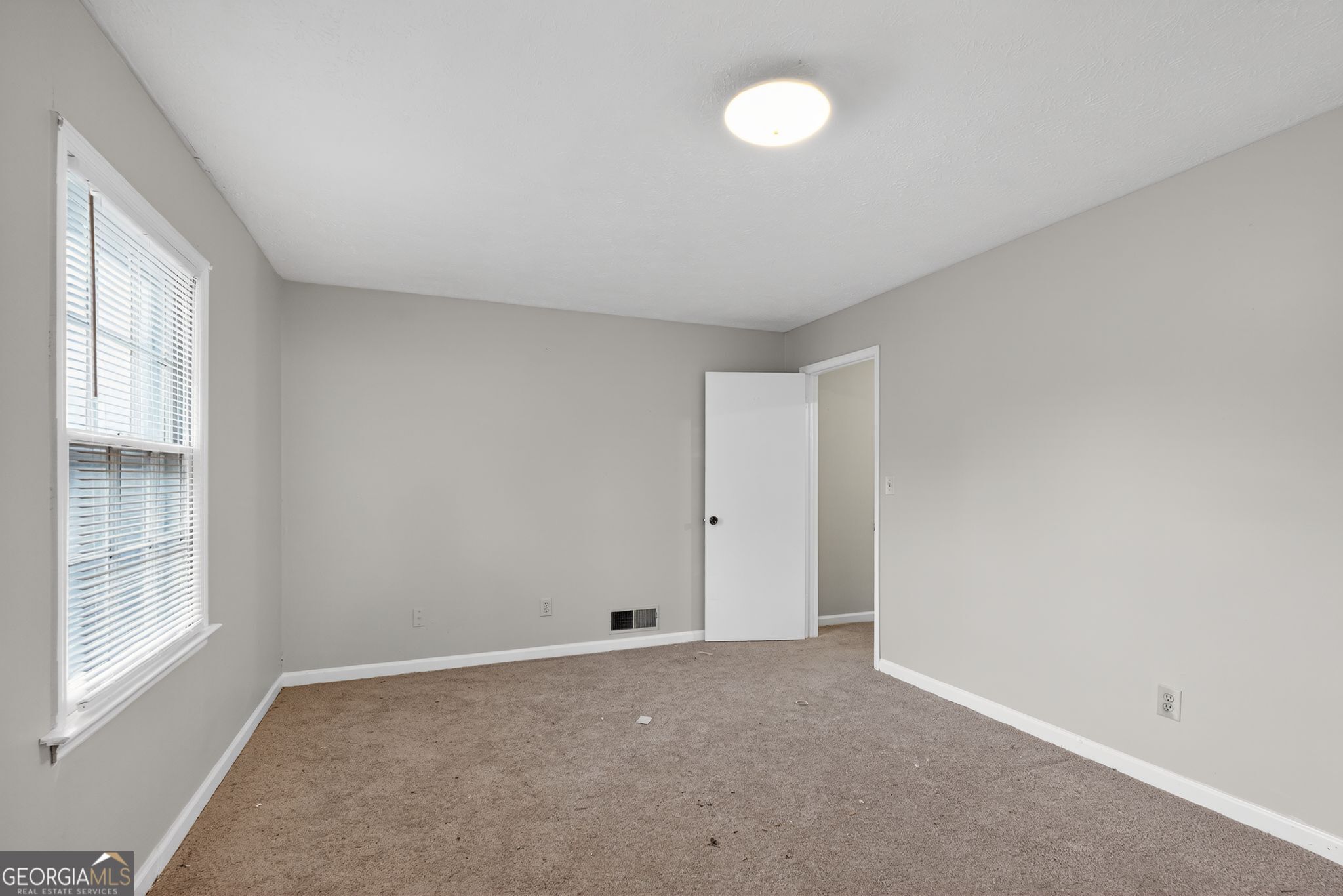 2653 Lester Street Atlanta, GA 30344 - Photo 4 of 34 a view of an empty room with a window