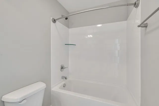 a bathroom with a bathtub and a toilet