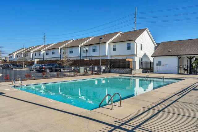 a view of a house with pool and chairs