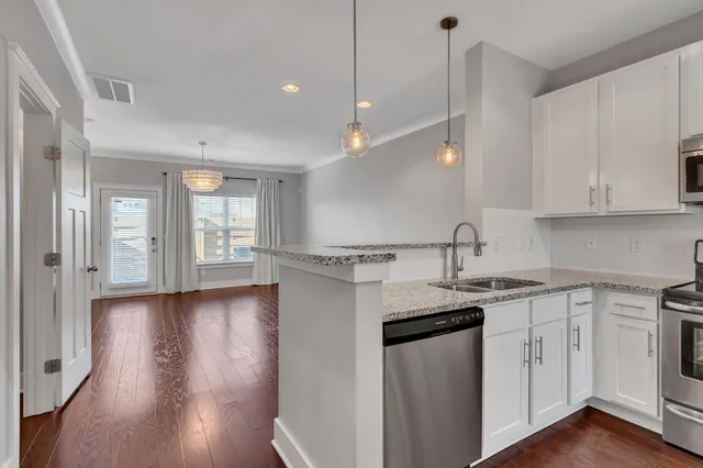 a kitchen with a sink window and cabinets