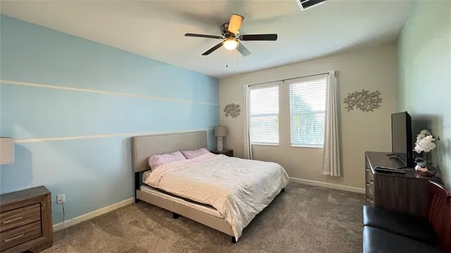 a living room with furniture chandelier and a window