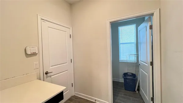 a kitchen with a sink a chandelier and a mirror
