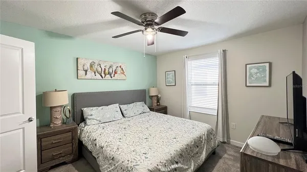 a view of a livingroom with furniture and a ceiling fan