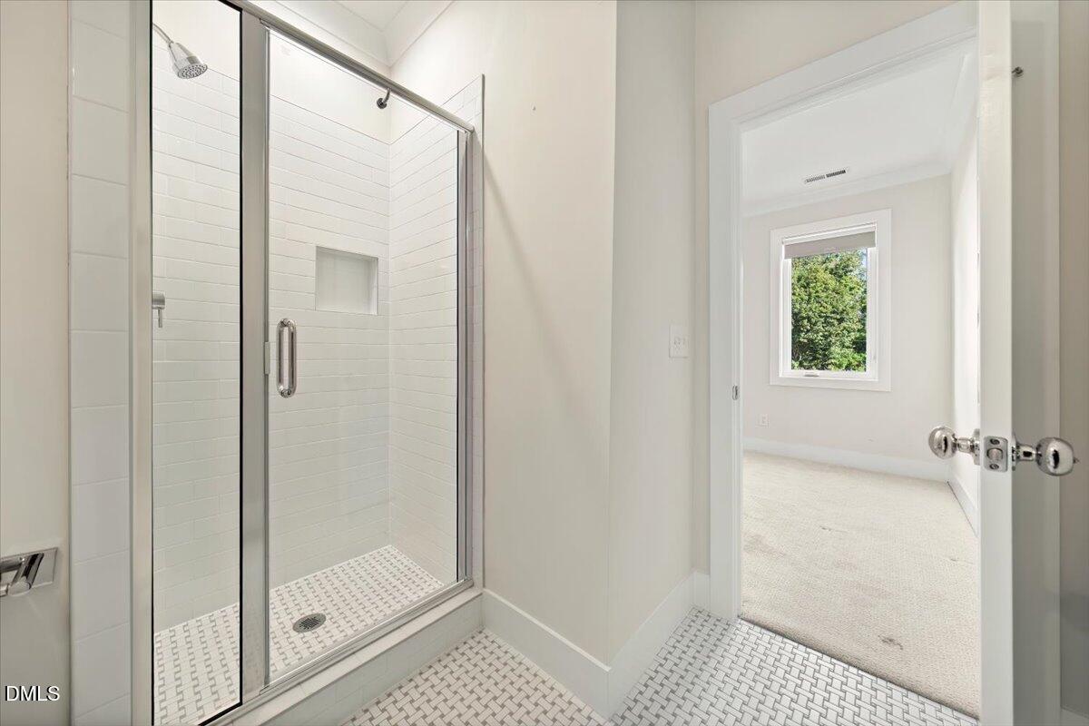 712 East Edenton Street, Unit 102 Raleigh, NC 27601 - Photo 12 of 17 a bathroom with a shower and a glass door