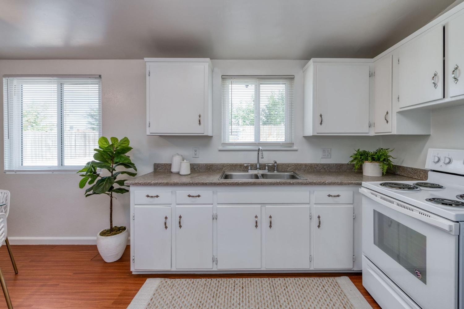 2607 Crescent Avenue Clovis, CA 93612 - Photo 12 of 26 a kitchen with white cabinets and a sink