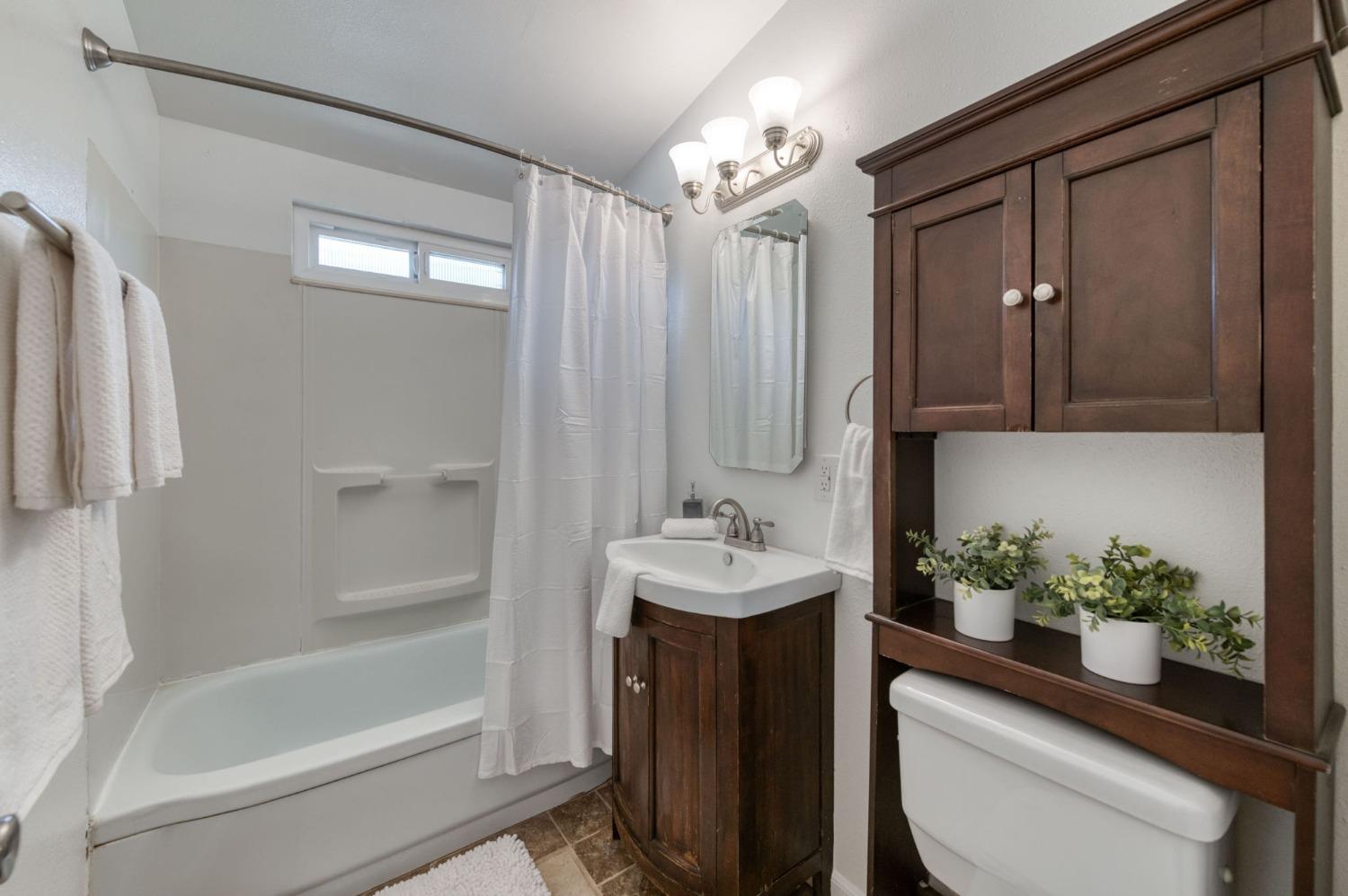 2607 Crescent Avenue Clovis, CA 93612 - Photo 14 of 26 a bathroom with a sink a toilet and shower