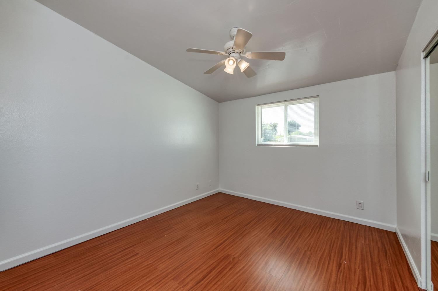 2607 Crescent Avenue Clovis, CA 93612 - Photo 15 of 26 a view of an empty room with wooden floor and a window